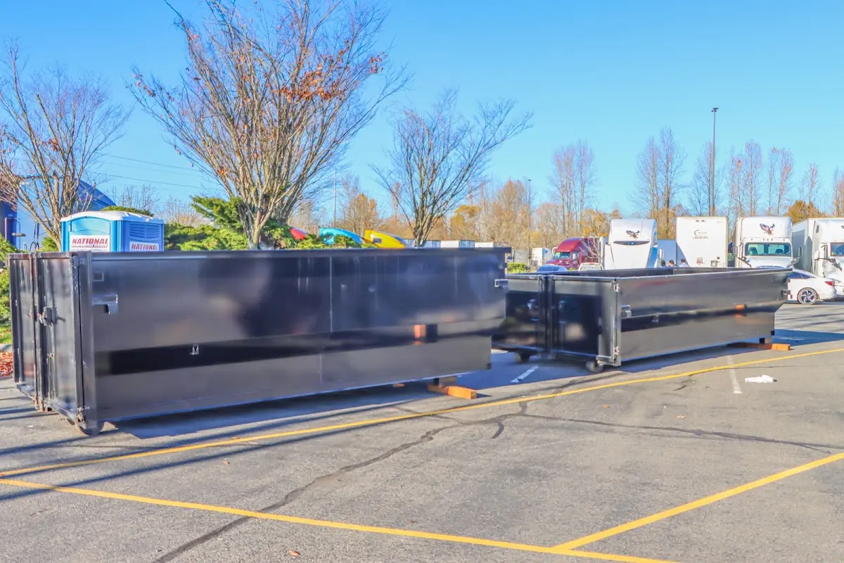 Professional dumpster rental service with roll-off container on residential driveway in Kapaa